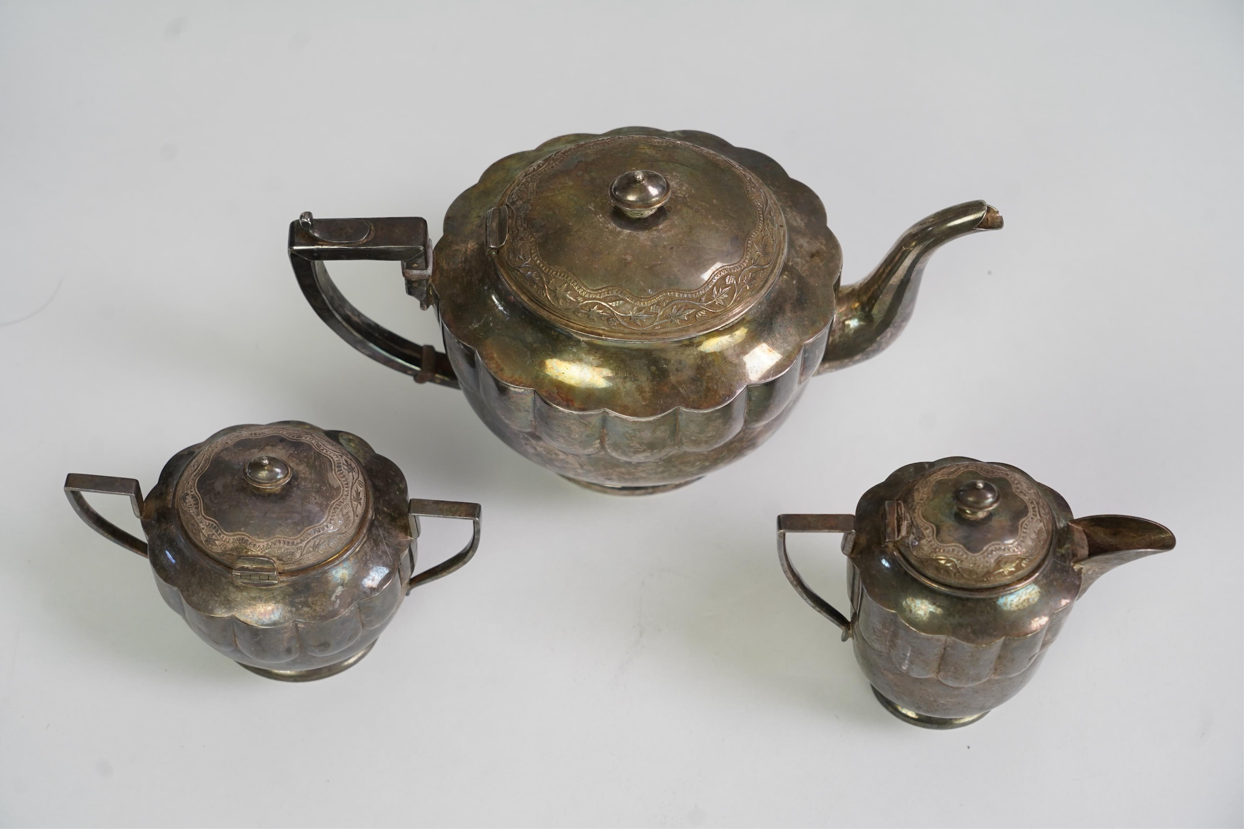 An early 20th century Indian white metal (tests as silver) three piece tea set